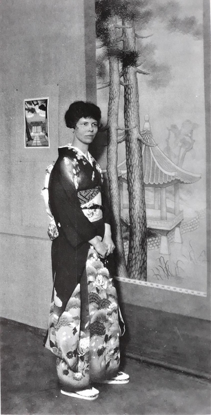 Lilian Miller at Grace Nicholson's gallery in April 1930 (behind her, the work that made her famous in 1920, In a Korean Palace garden, ink on paper, and, in small, a Korean Shrine, 1928)